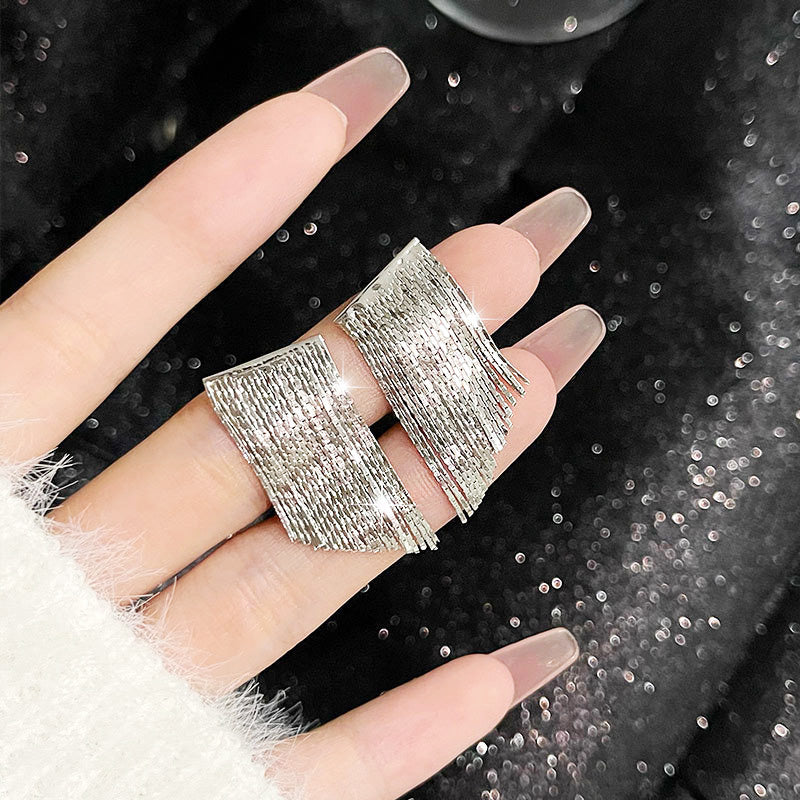 Model showcasing the elegant drape and size of the 925 sterling silver tassel earrings.