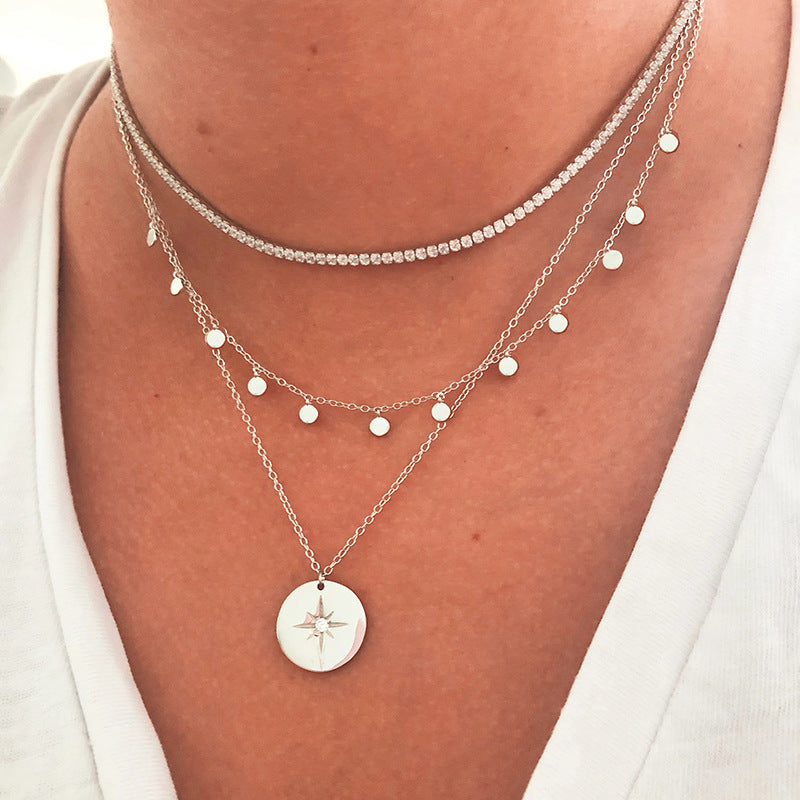 The North Star pendant necklace in a classic 925 sterling silver finish, shown layered.