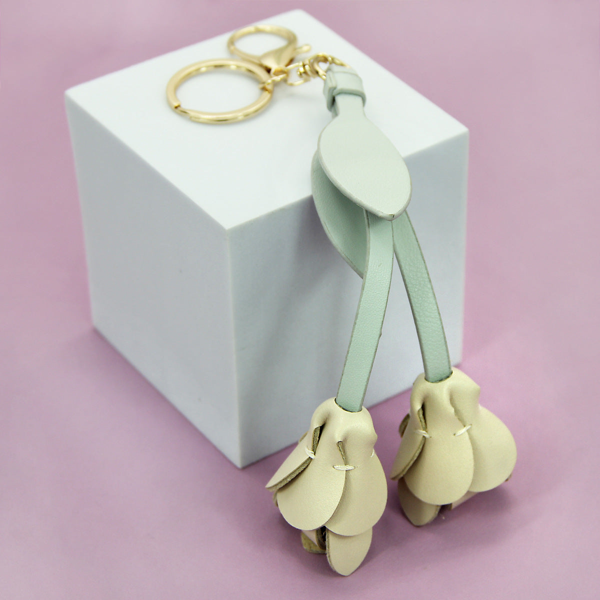 Soft beige tulip PU leather flower keychain shown up close