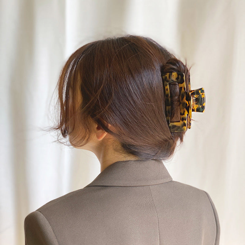 A model wearing a leopard print claw clip.