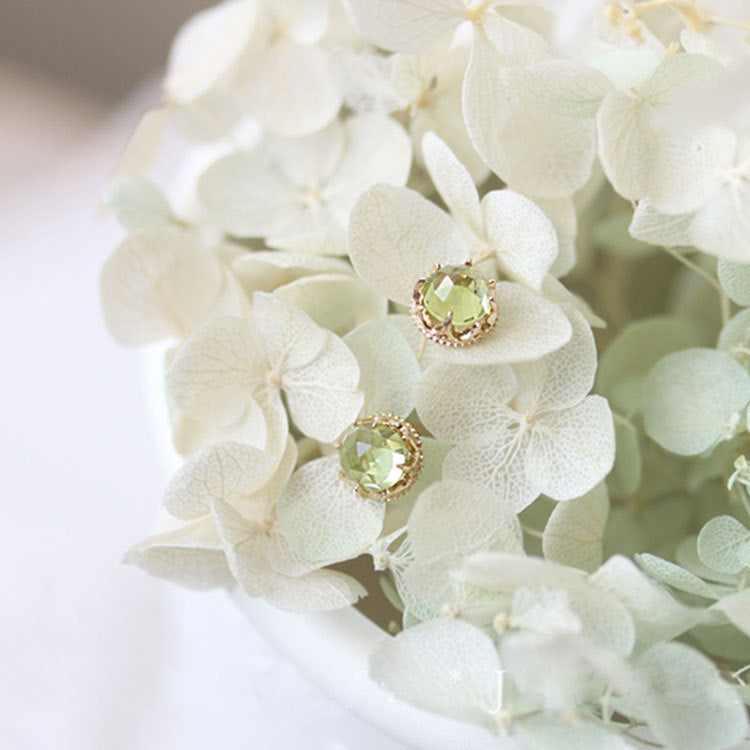 18K gold plated peridot earrings on white flowers