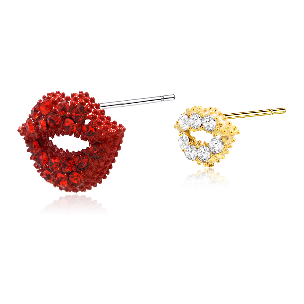 Detailed view of the red and gold lip-shaped earrings with sparkling gemstones
