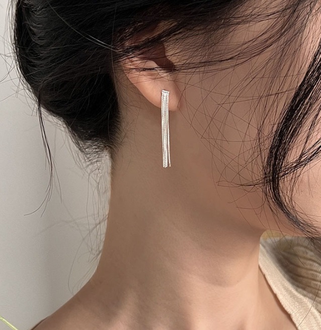 Model showcasing the elegant drape of the sterling silver tassel long earrings.