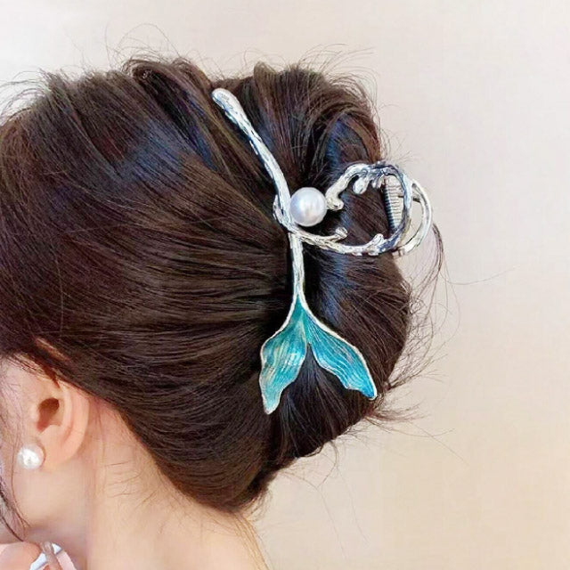 Mermaid tail hair clip adding a stylish accent to a hair bun.
