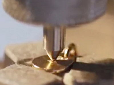 Close-up of traditional engraving on a metal tag