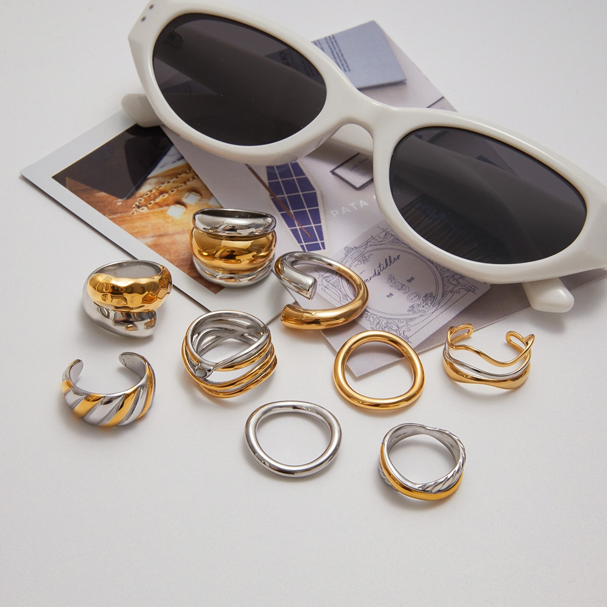 PVD gold and silver stainless steel rings displayed with fashion accessories