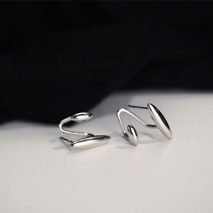 Modern sterling silver wrap cuff earrings with an abstract design.