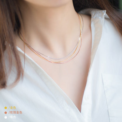 A layered look of the 925 sterling silver snake chain necklaces in gold, rose gold, and silver.