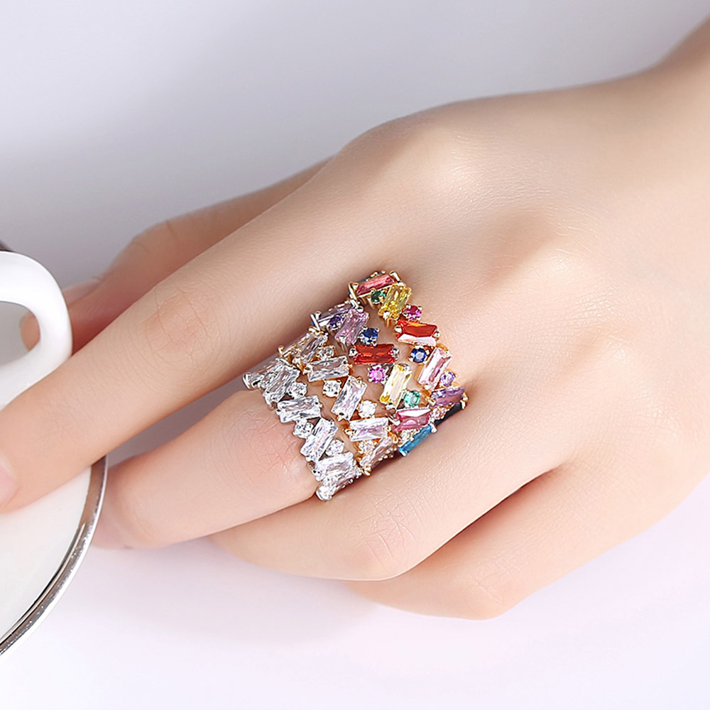 A model's hand showcasing the stacked ZigZag Rainbow Baguette Rings