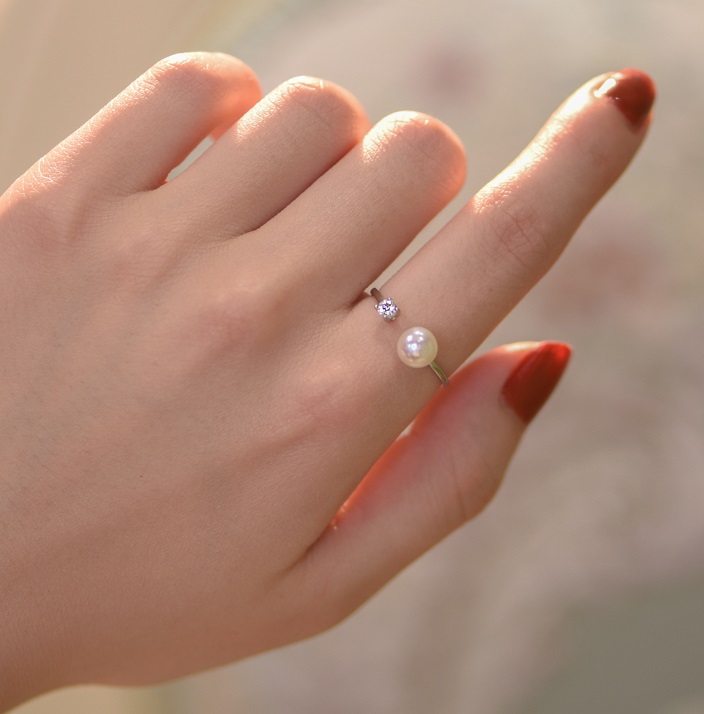 Side view of the Pearl and Diamond Opening Ring showcasing the adjustable band