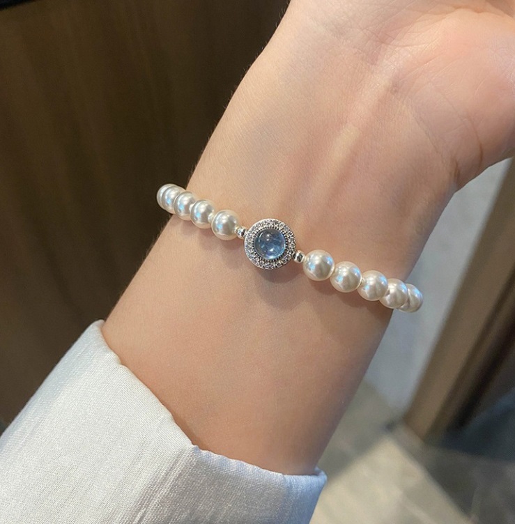 Detailed view of the pearl and blue gemstone bracelet clasp