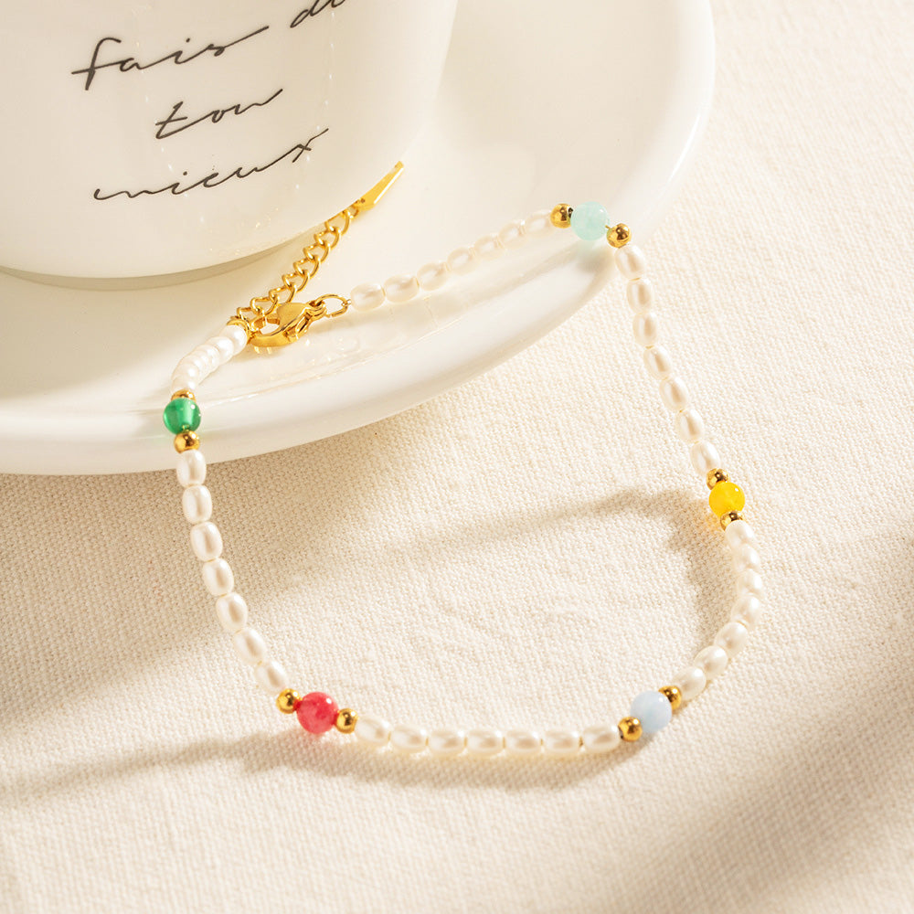 Close-up of the intricate beadwork on the pearl and stainless steel anklet