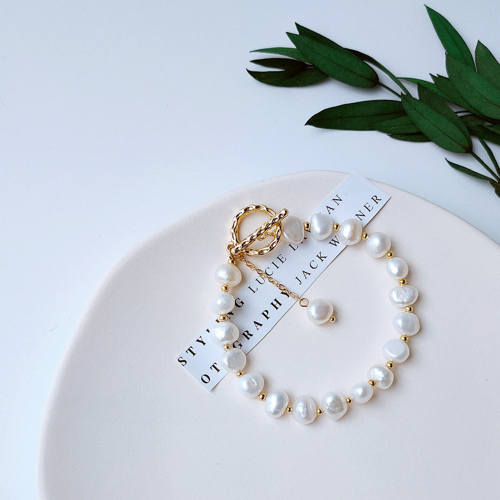 A set of 14k gold-plated baroque pearl bracelets displayed elegantly.