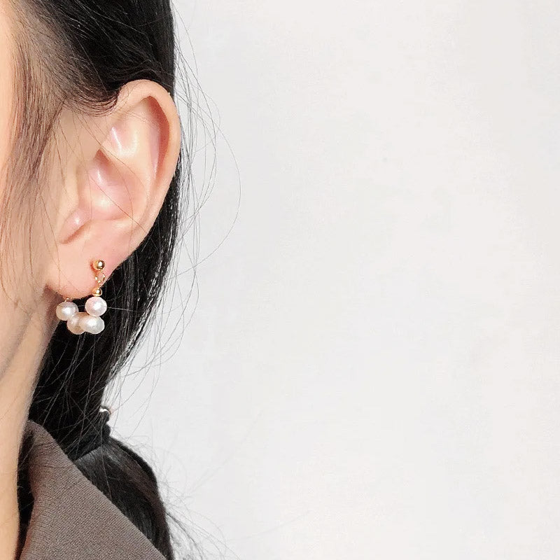 Model showcasing the elegant fit of the baroque pearl stud earrings