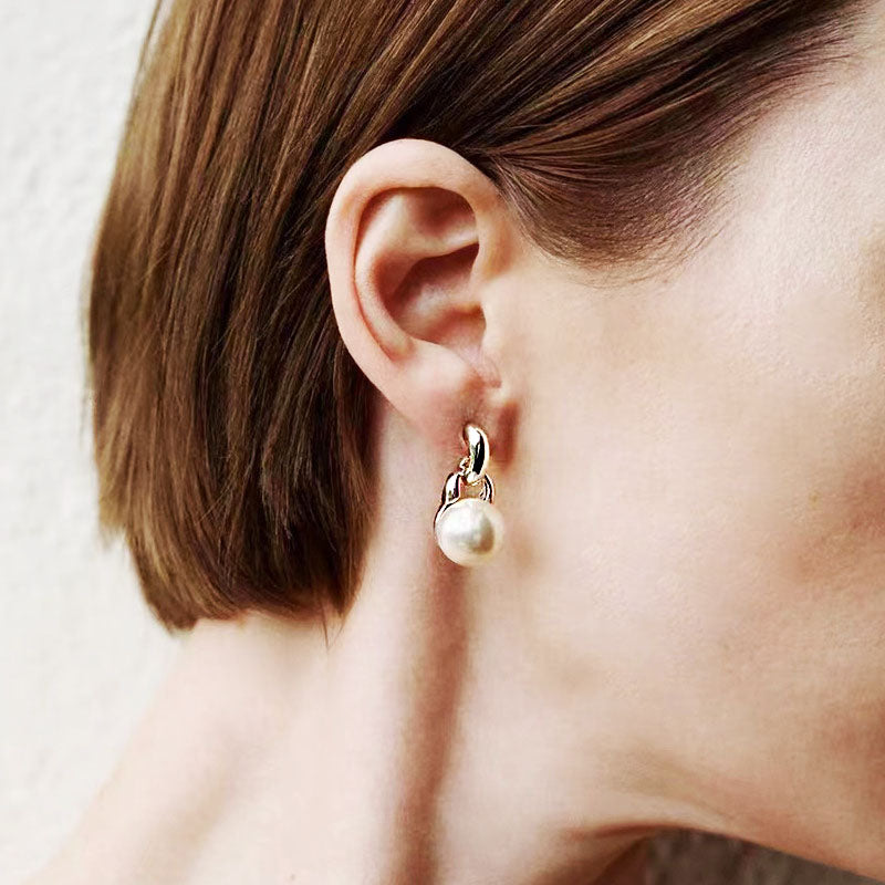 A model showcasing the elegant single pearl drop earring.