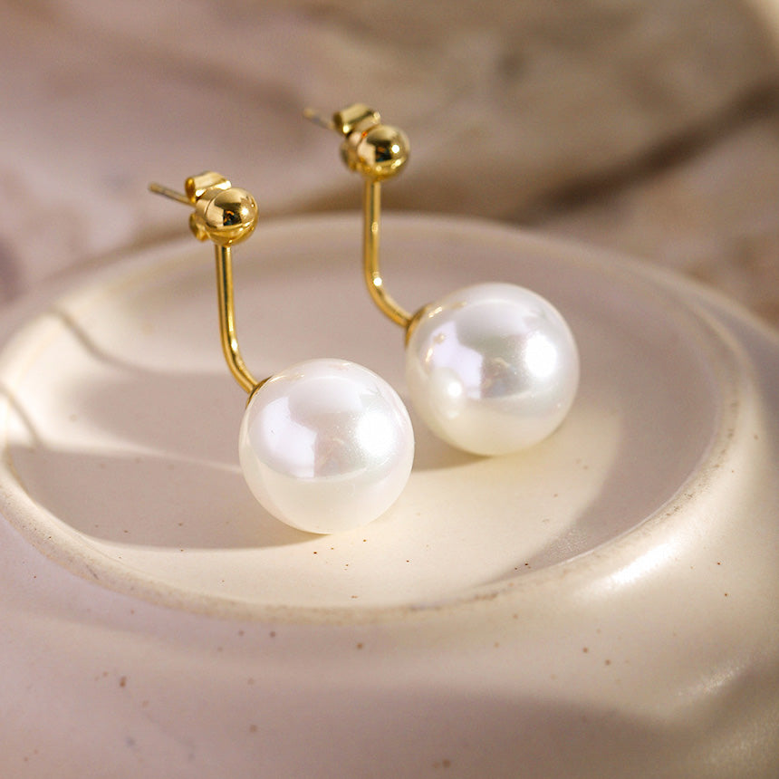 Detailed view of the gold finish on the French-style pearl stud earrings