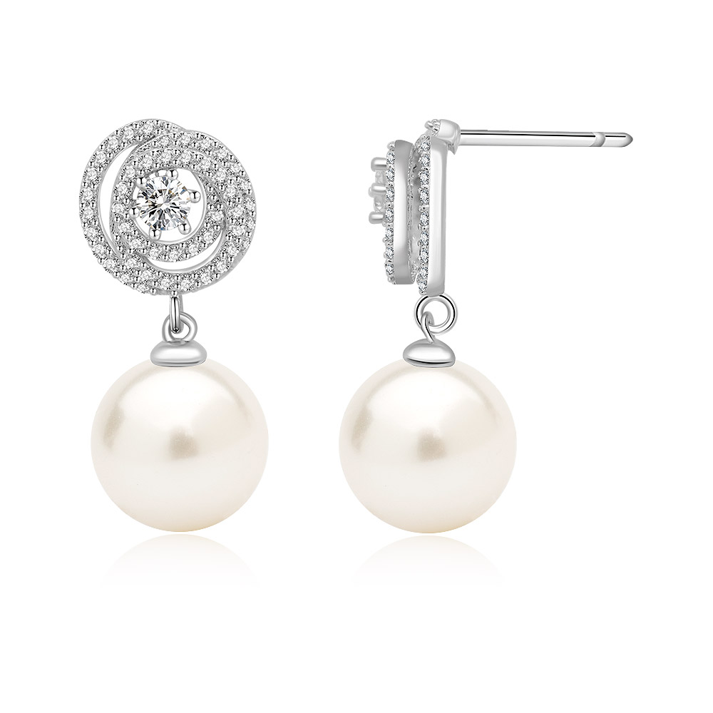 Detailed view of the pearl earrings with diamond settings