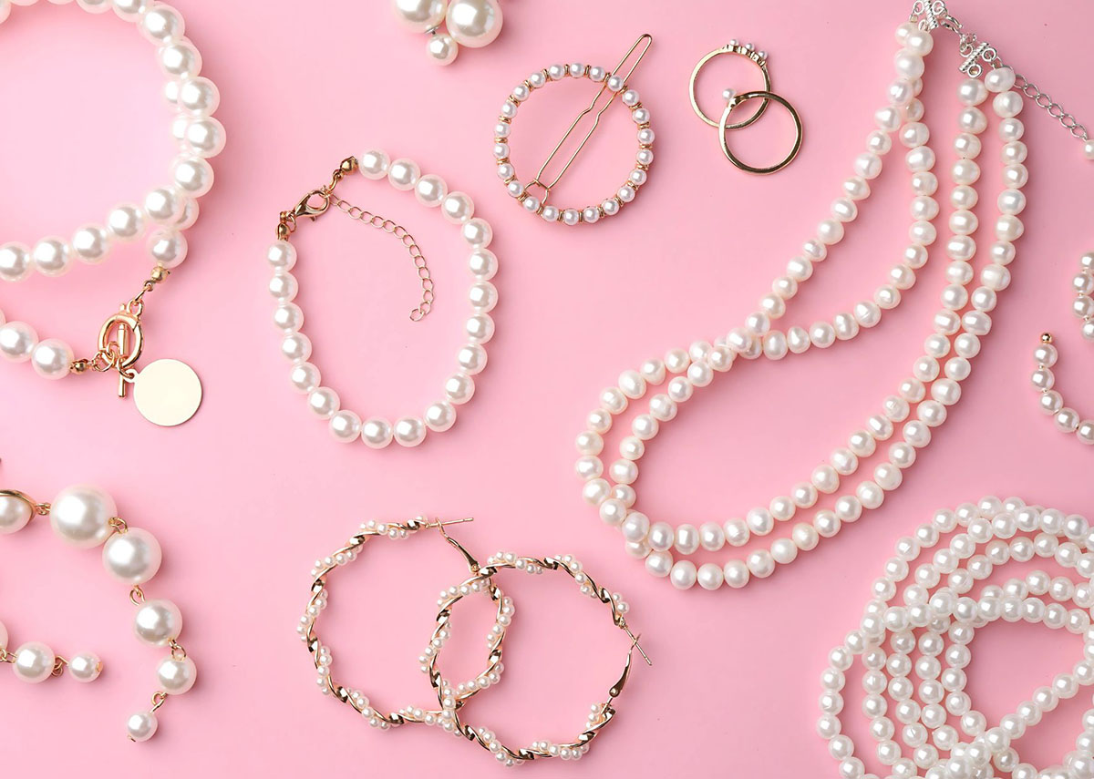 A collection of custom pearl jewelry including necklaces, bracelets, and earrings.