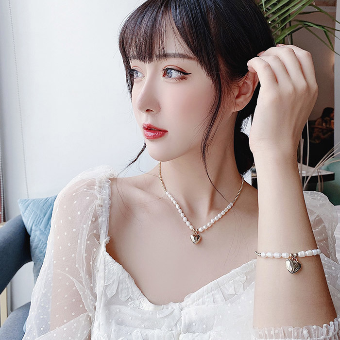 Model showcasing the Valentine Heart Pendant Pearl Necklace