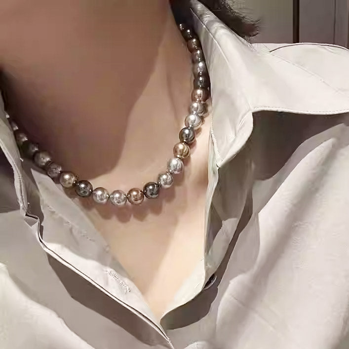 A model showcasing the elegant fit of the Morandi-colored pearl necklace.