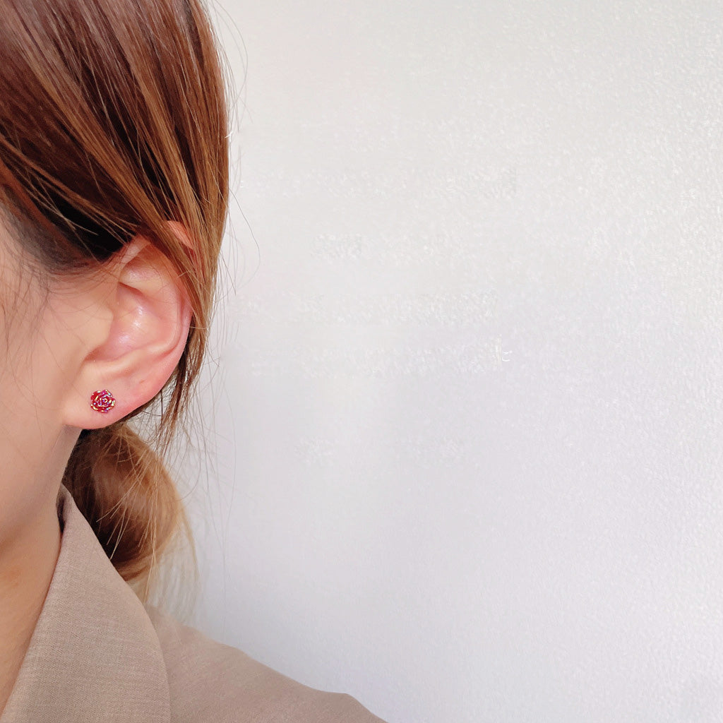 Model wearing the mini red rose stud earring