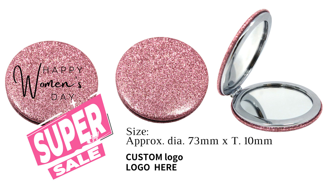 A close-up of the pink glittery compact mirror held in hand, showcasing its texture and size.