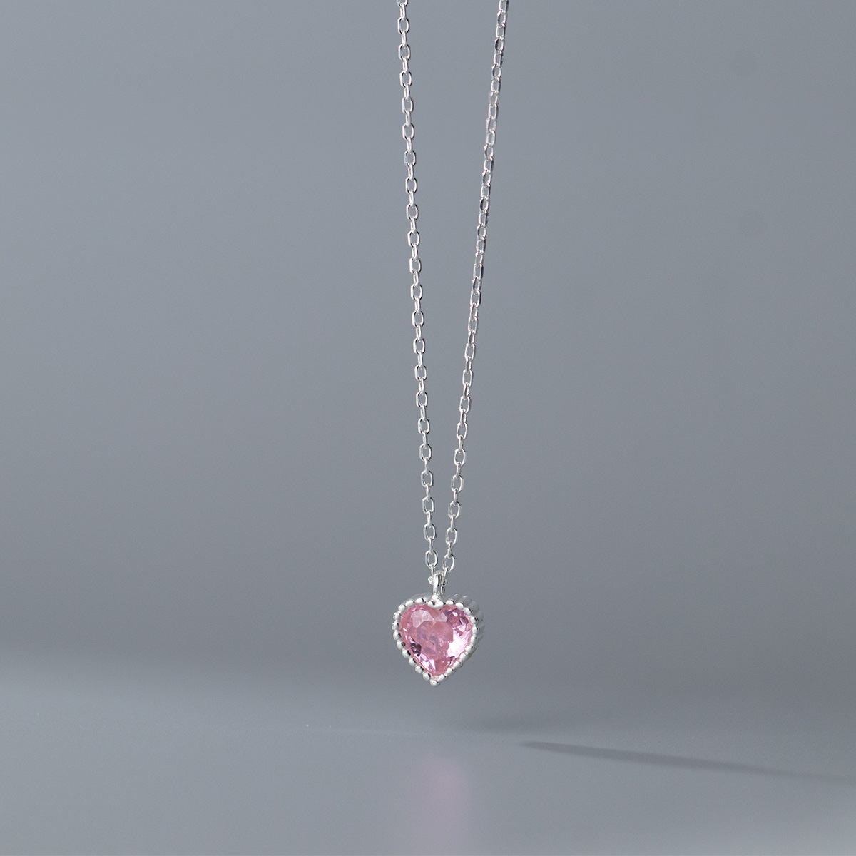 Detailed view of the pink heart gemstone pendant