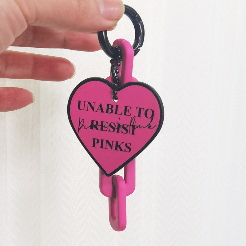 Pink PU leather heart keychain attached to a key