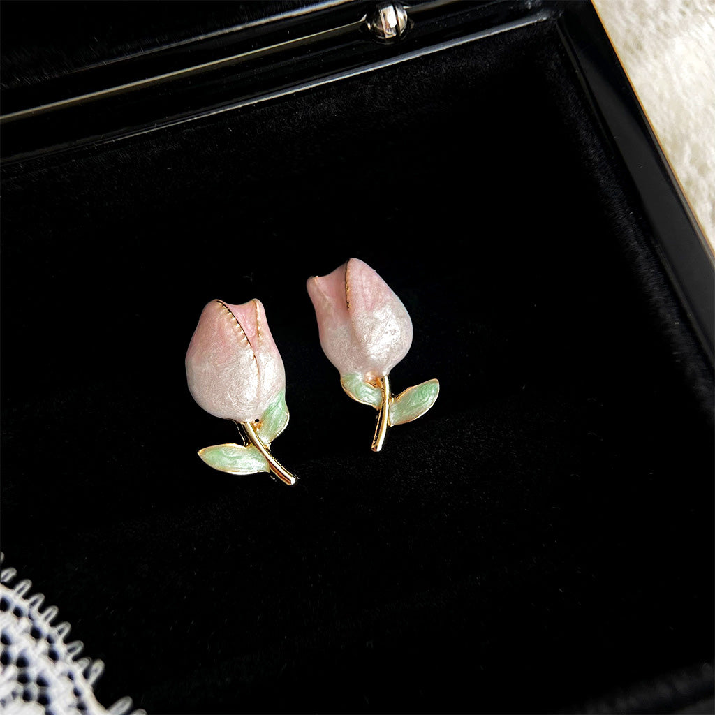 Detailed view of the 14k gold plated tulip earrings on a display tray