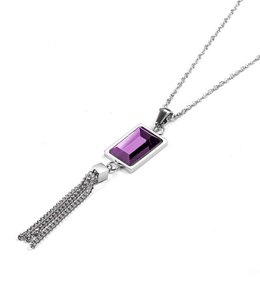 Detailed view of the silver tassel necklace with purple gemstone