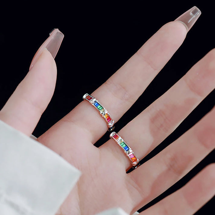 A model's hand showcasing two of the 925 sterling silver rainbow zircon rings.