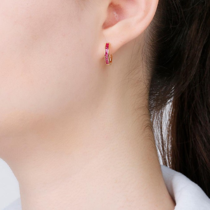 Model showcasing the elegant fit of the Baguette Mini Huggies Hoop Earring.