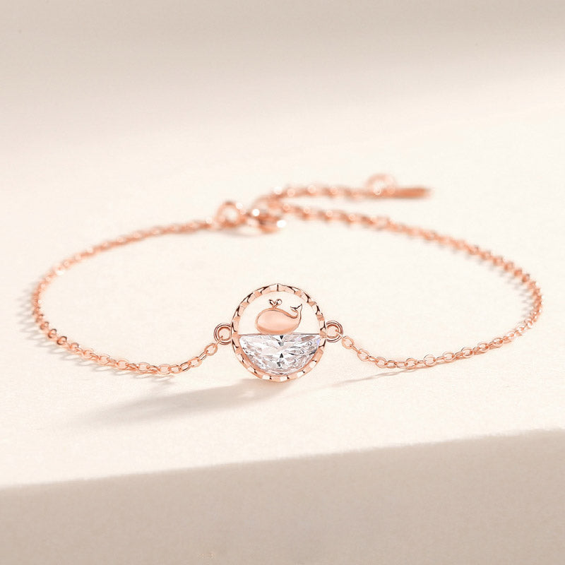 Detailed view of the rose gold whale charm bracelet