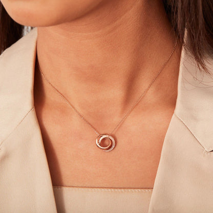 A model wearing the Eternal Circles necklace in rose gold, showcasing its elegant drape.