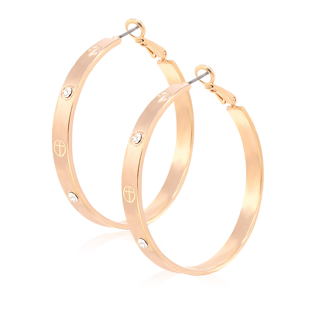 Detailed view of the rose gold hoop earrings with engraved symbols