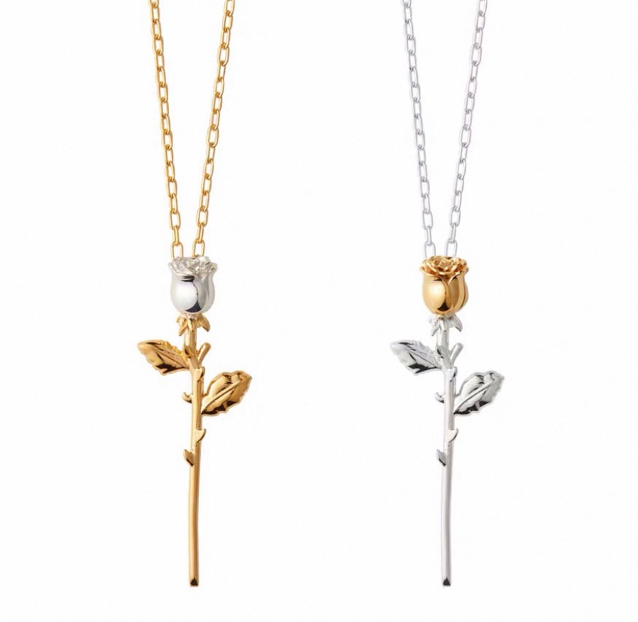 Two versions of the Dainty Rose Necklace, one with a gold chain and silver rose, and the other with a silver chain and gold rose.