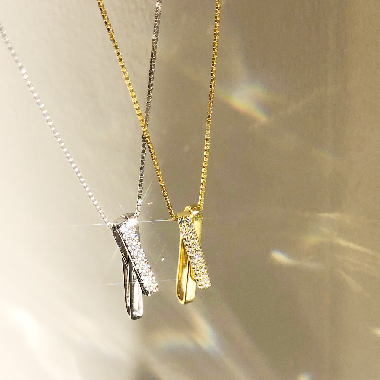 Close-up of the 925 Sterling Silver Cross Necklace in silver and gold finishes