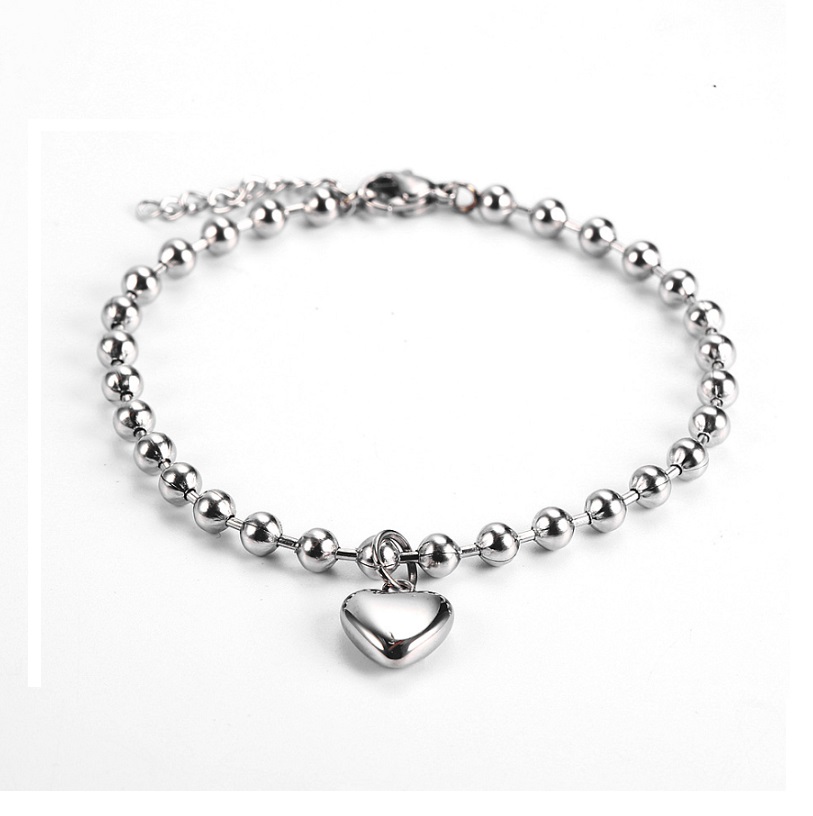 The Heart Charm Beaded Bracelet shown in a sleek silver finish