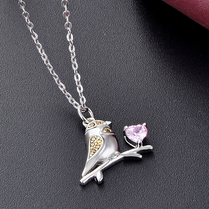 Detailed view of the sparrow bird pendant with pink heart zircon