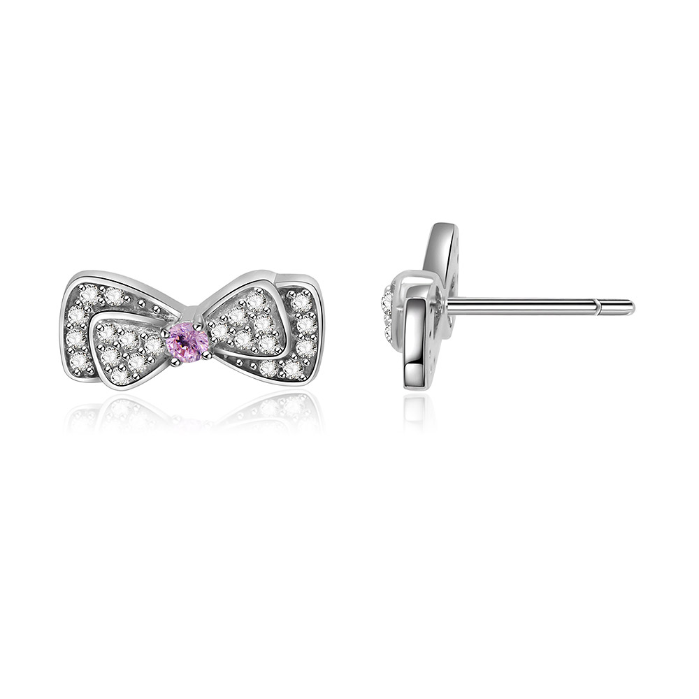 A close-up of the Mini Silver Bow Stud Earrings showing the pink and clear stones