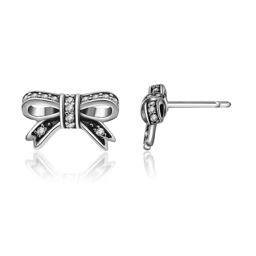 Multiple views of the silver bow stud earrings