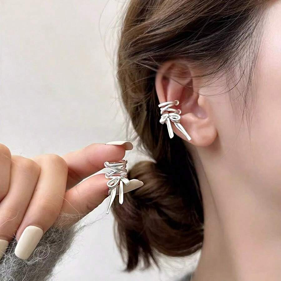 Model showcasing the delicate design of the silver bowknot earrings