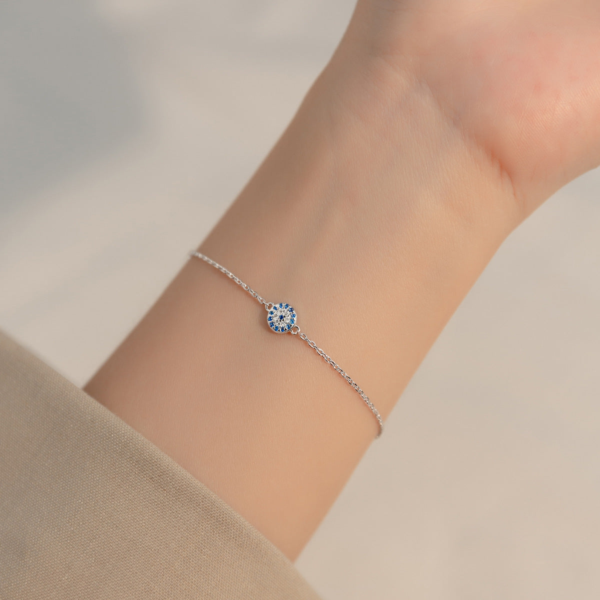 A model wearing the 925 silver evil eye bracelet to showcase its fit and style.