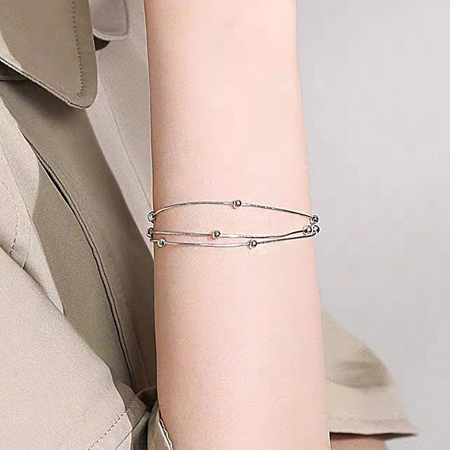 Model wearing the 925 sterling silver multi-layer snake chain bracelets
