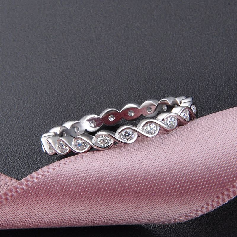 Detailed view of two sterling silver twist rings with gemstones