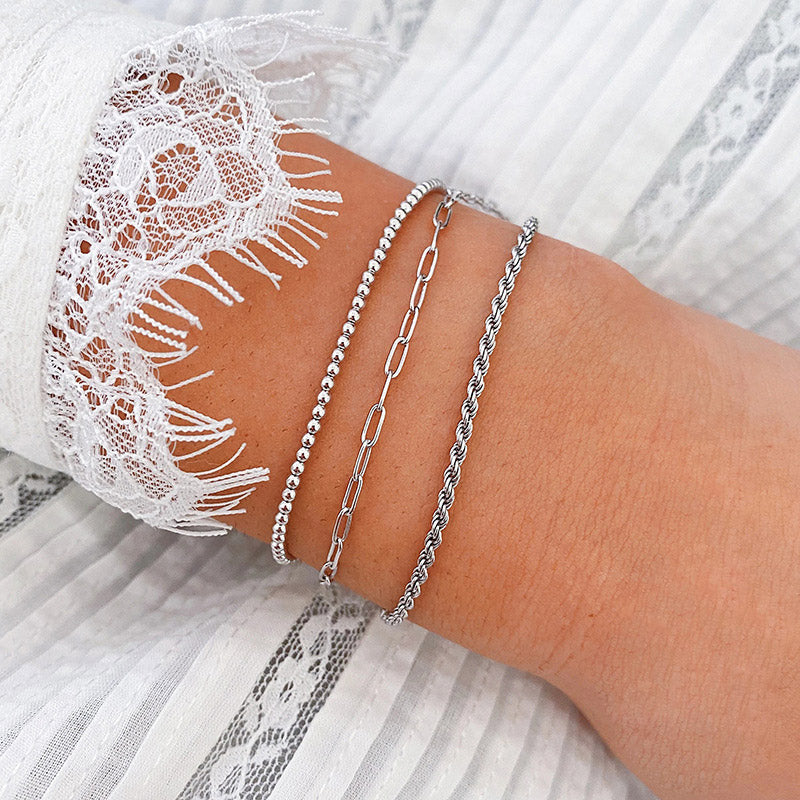 A set of 925 sterling silver paper clip bracelets on a wrist