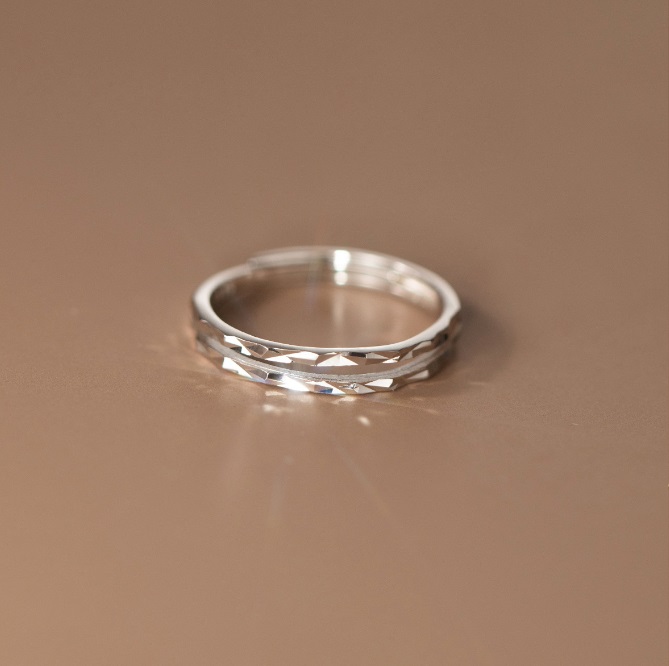 Detailed view of the silver faceted ring's texture and craftsmanship.