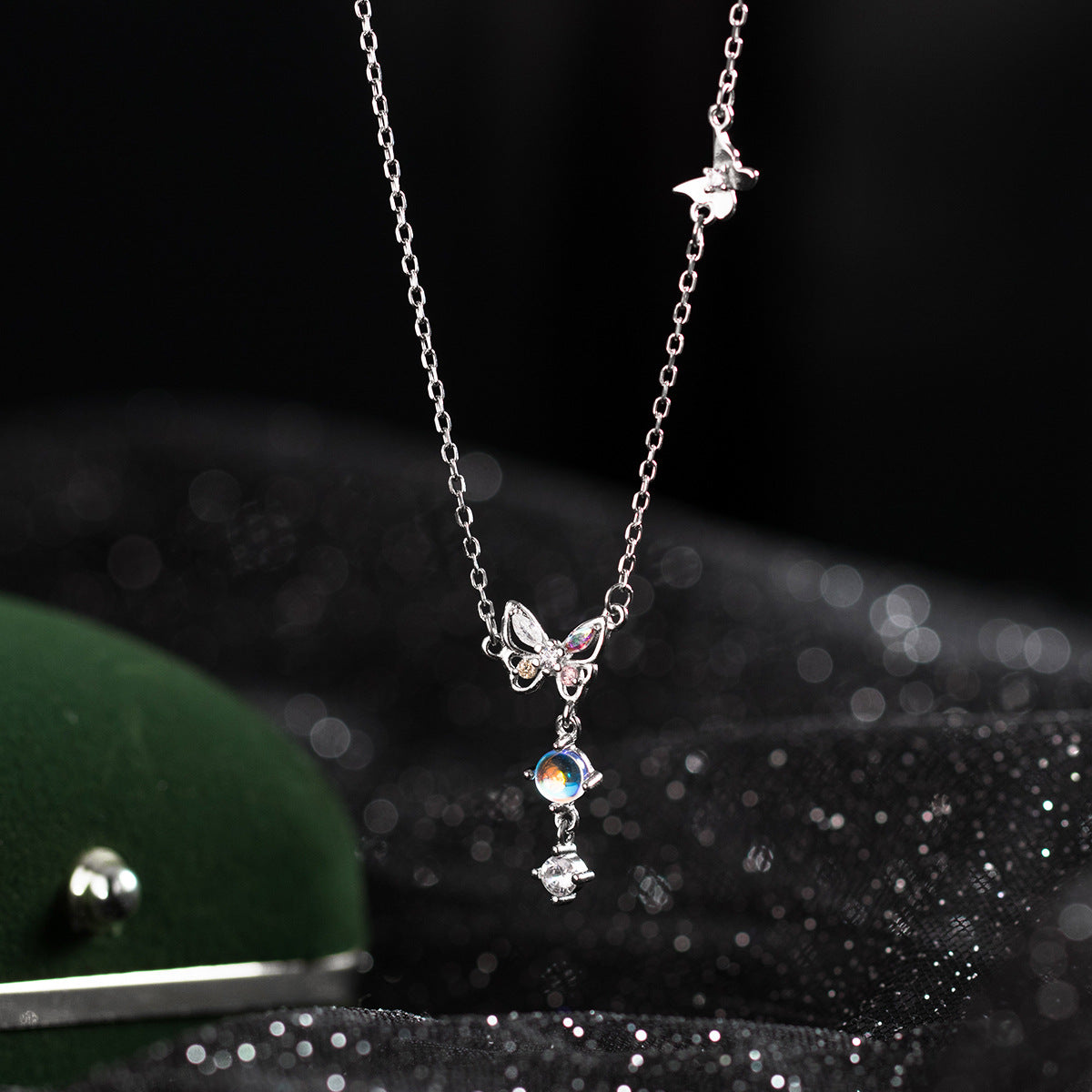 Detailed view of the 925 sterling silver butterfly pendant with iridescent zircon stones