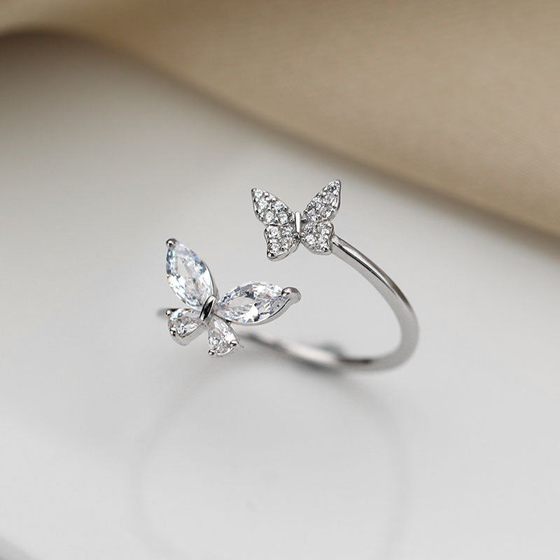 Close-up of the dual butterfly design with cubic zirconia detailing
