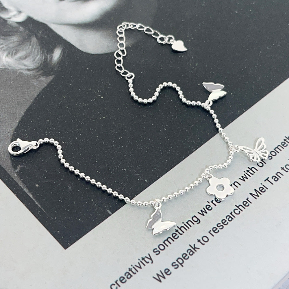 Detailed view of the silver ball chain and charms on the 925 sterling silver bracelet